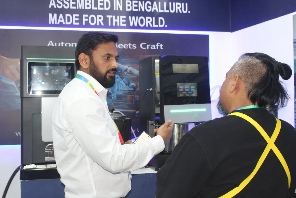An Automat team member demonstrating a machine to a visitor