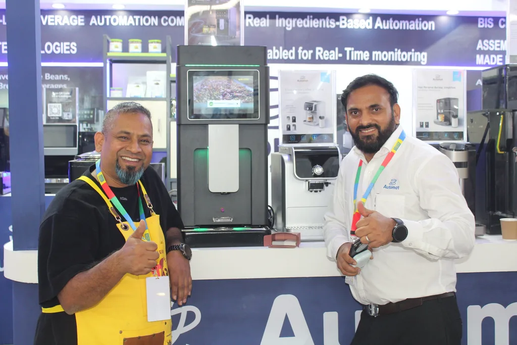A visitor and an Automat team member at the booth