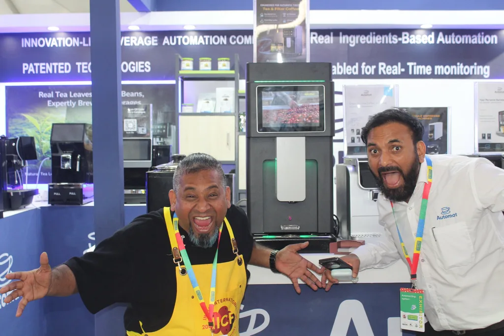 An Automat team member welcoming a visitor at the booth