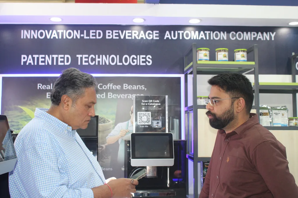 A visitor looking at an Automat machine's touchscreen with a team member