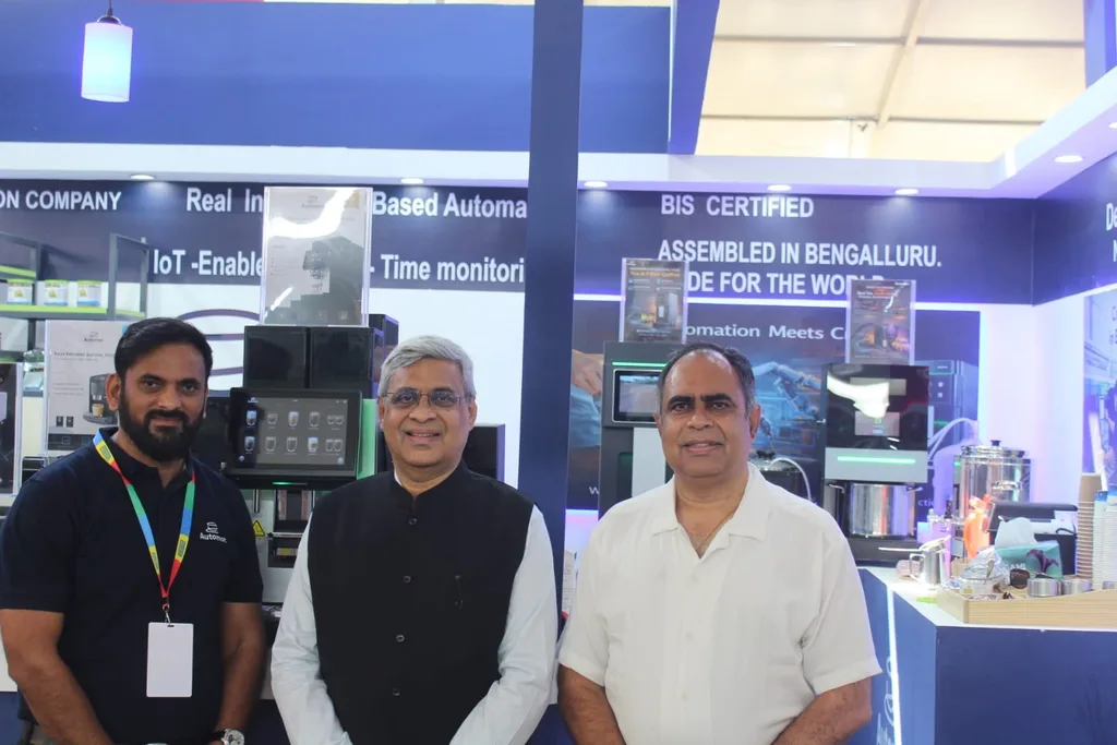 Three people standing together at the Automat booth