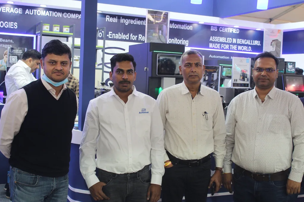 A group of Automat team members and visitors at the booth