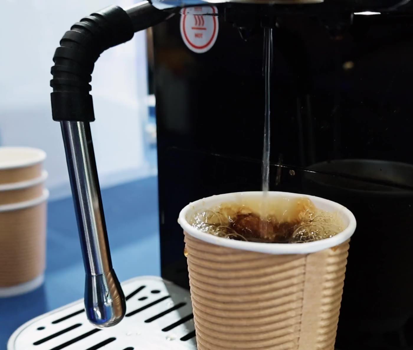 Coffee dispensing from AT-103S beside the fitted steam wand