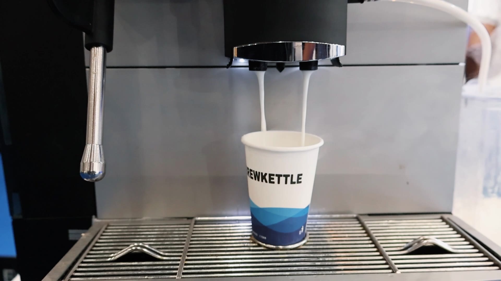 Milk and coffee dispensing from E60 Pro into a cup
