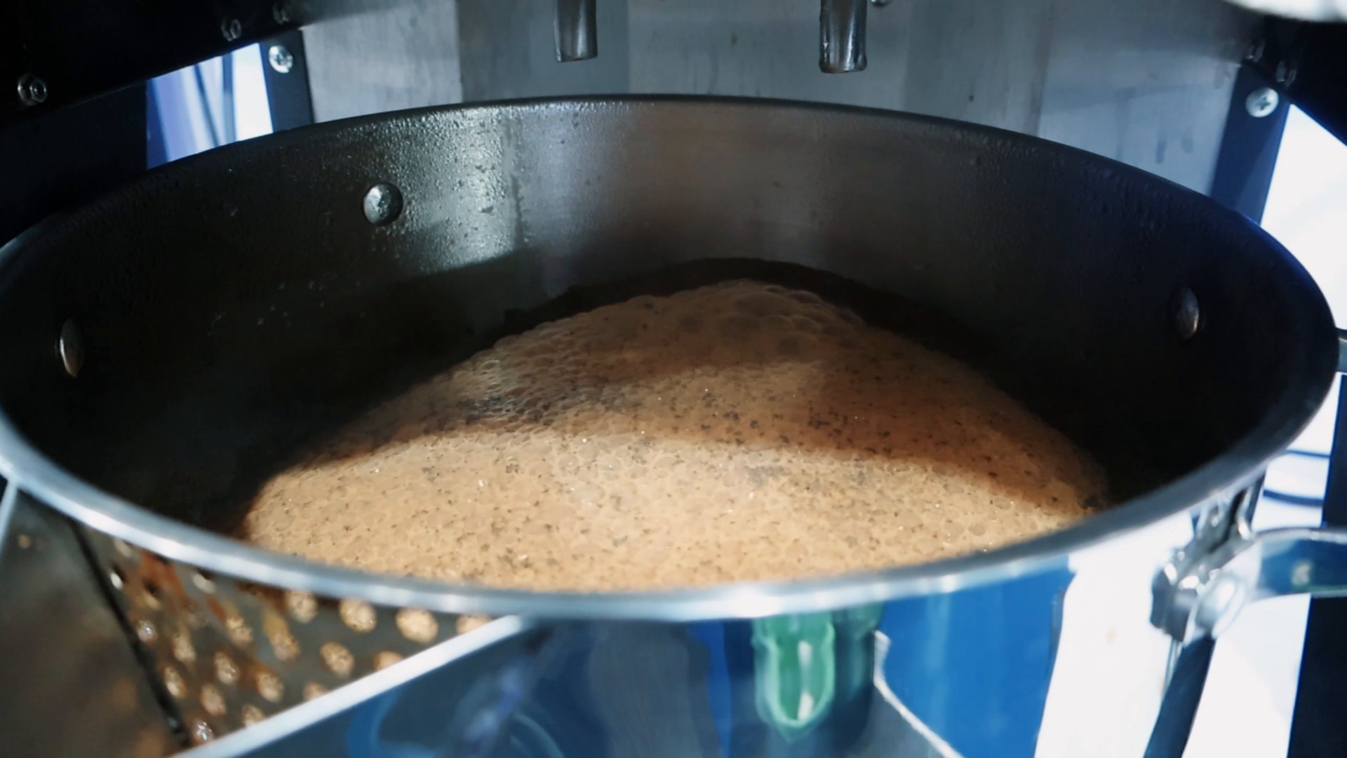 Chai boiling to a froth inside the BrewNex stainless-steel pot